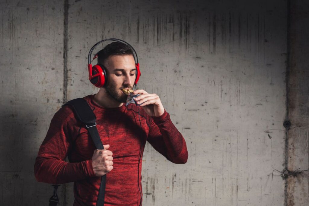 Athlete eating protein bar after training