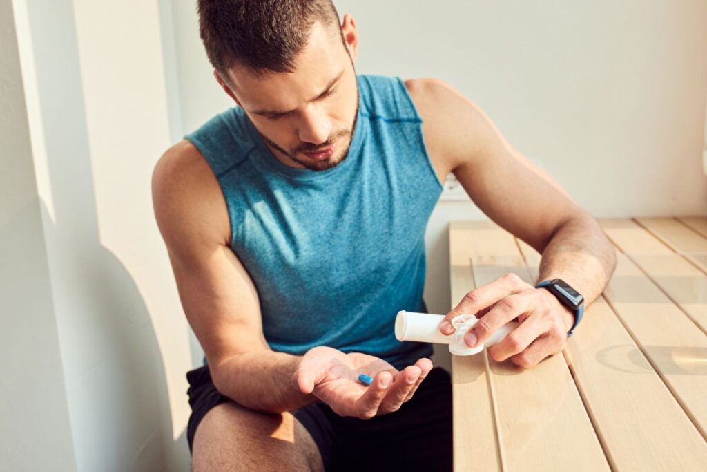 athlete taking capsules before training