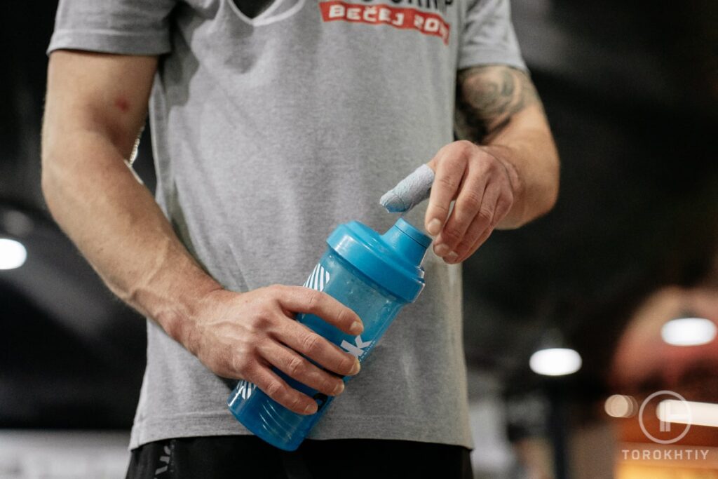 Athlete drinking mass gainer during training