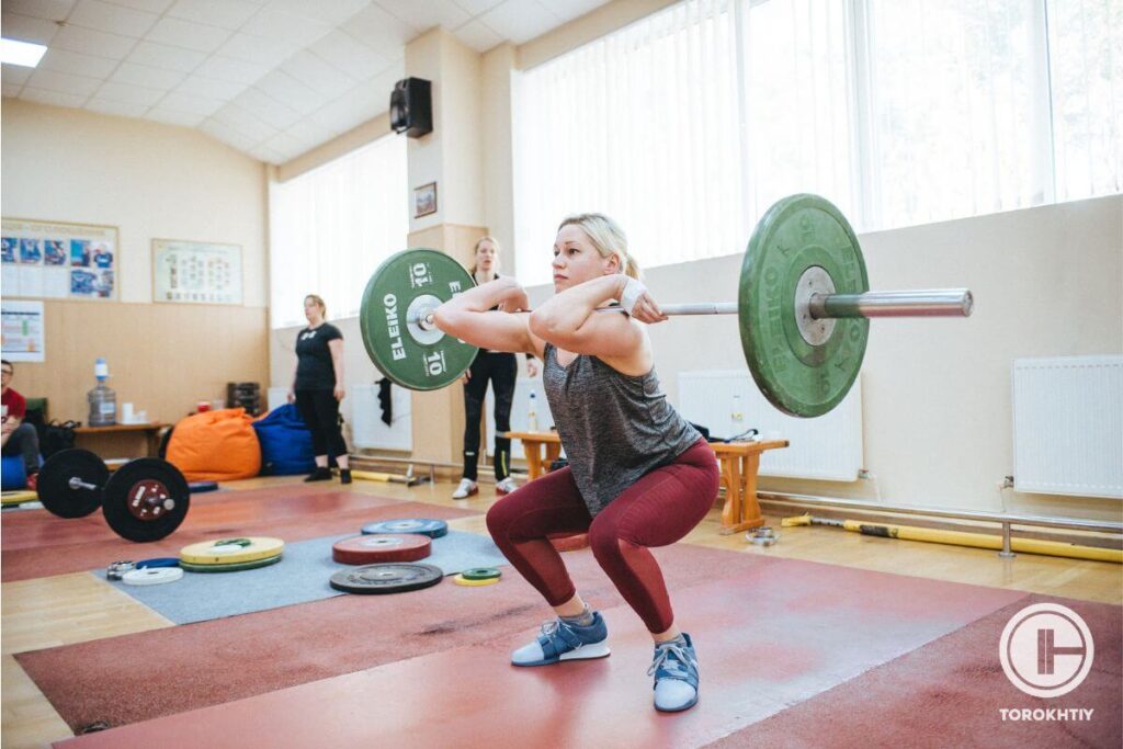 Female Front Squatting in Gym