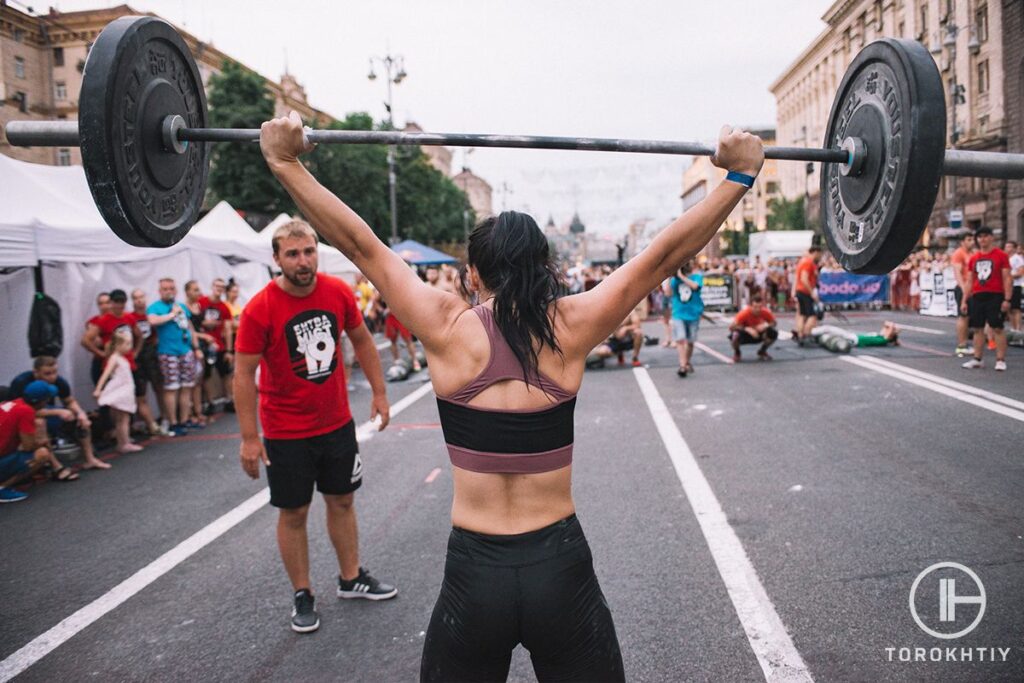 Girl workouts with barbell