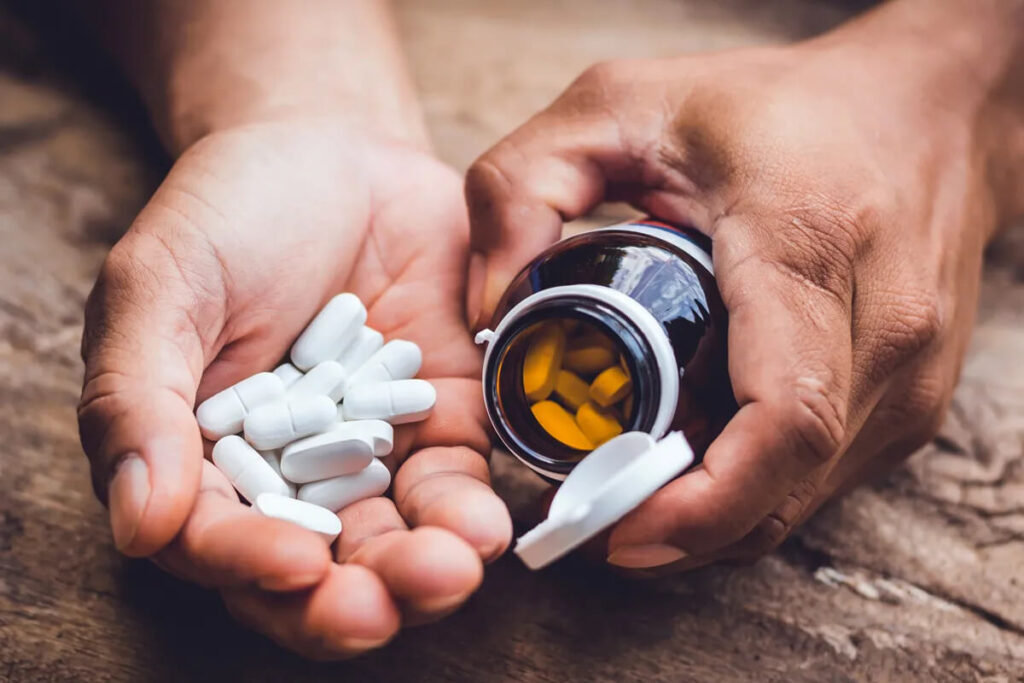 Man Holds Multivitamins