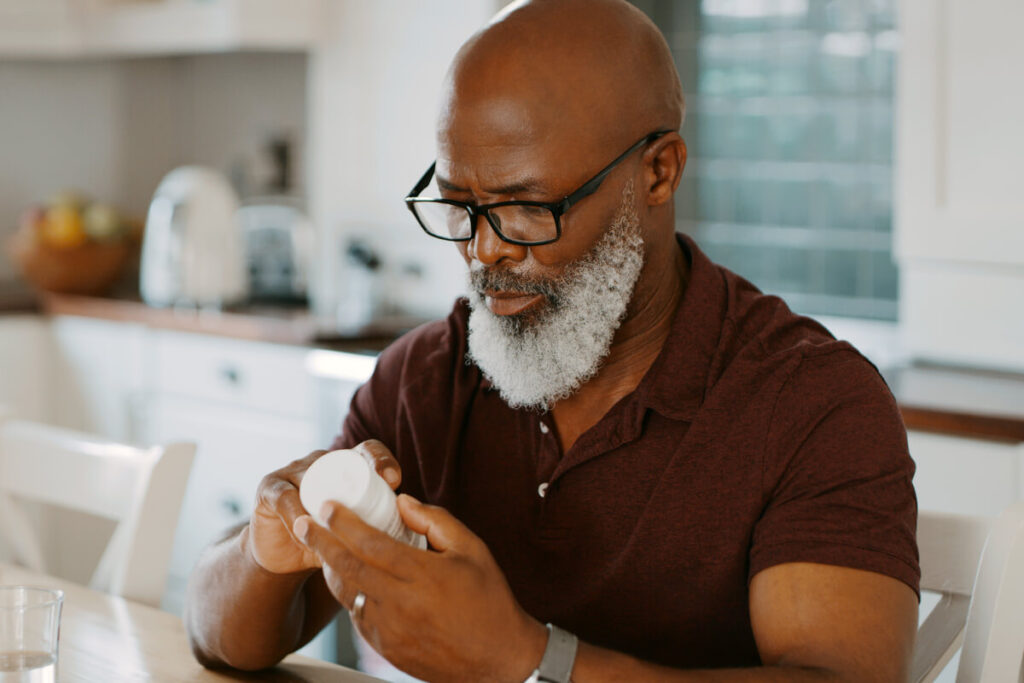 Man Reads Multivitamins Instruction