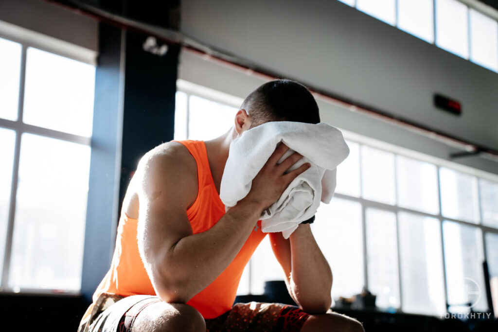 Man Rubs with Towel After Workout