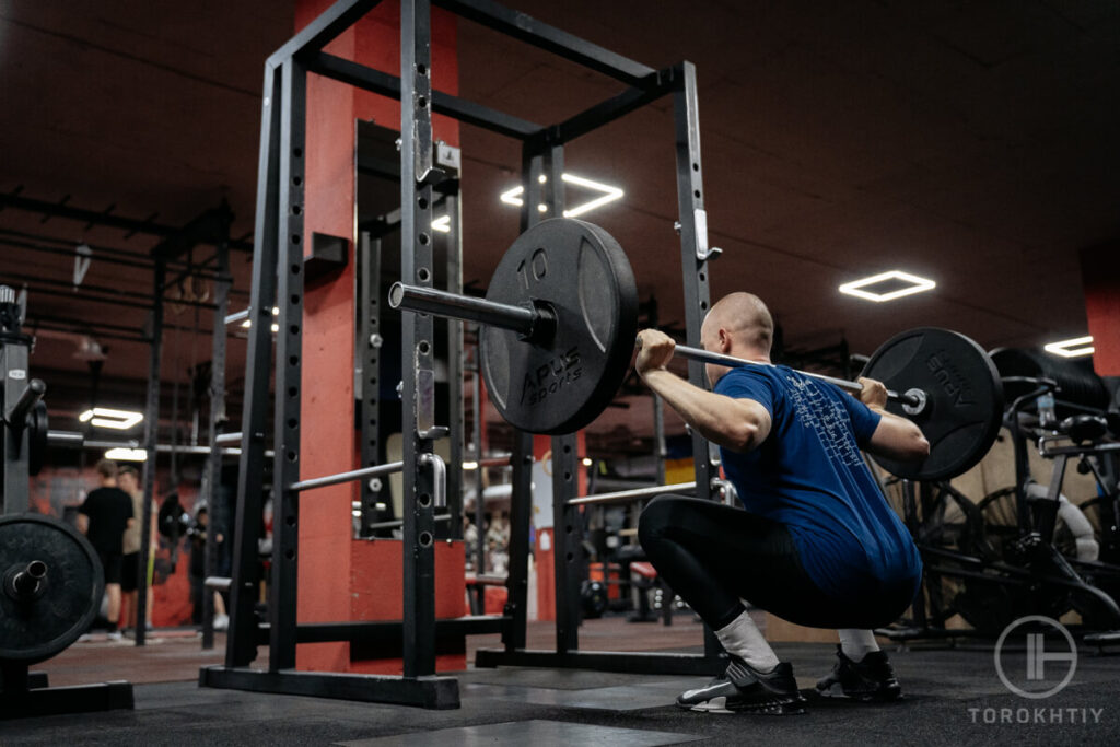 Man Squatting in the Gym