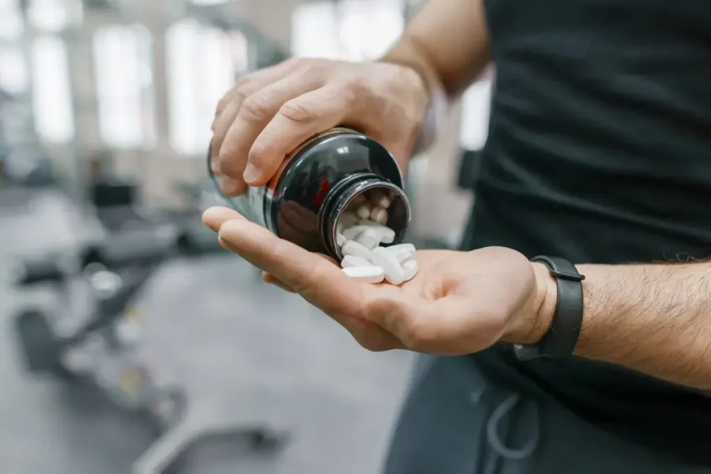 Man Takes Multivitamins from Bottle