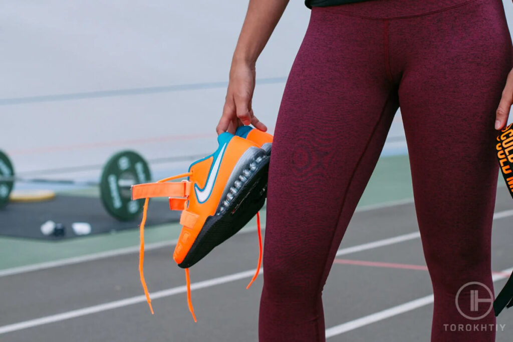 Woman Showcasing Weightlifting Shoes