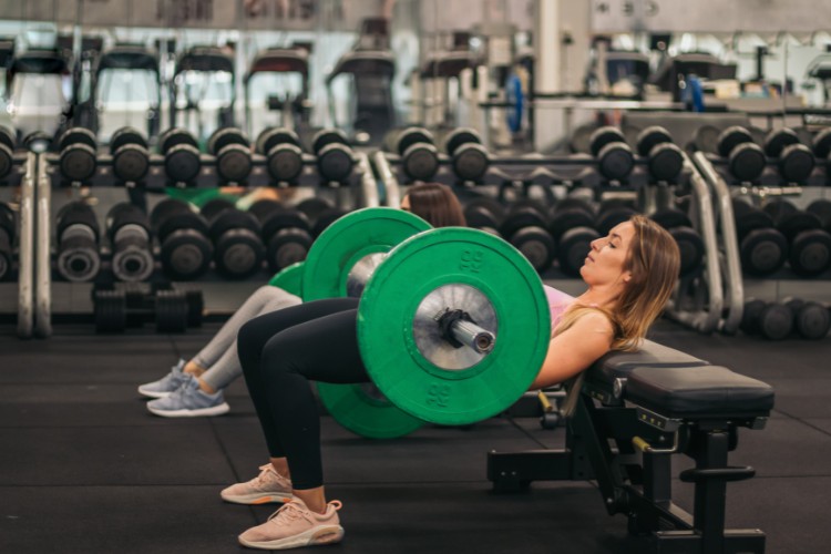 Performing Bar Hip Thrusts