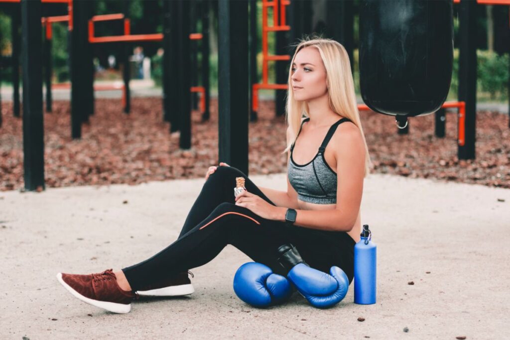 Fitness Girl Eating Protein Bar