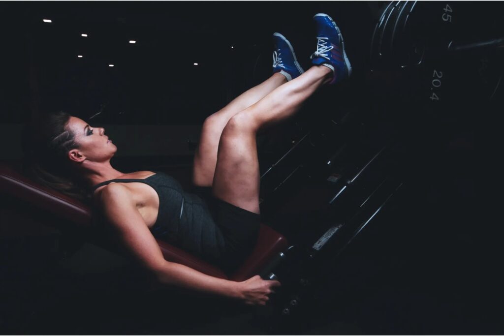 Female athlet performing leg press