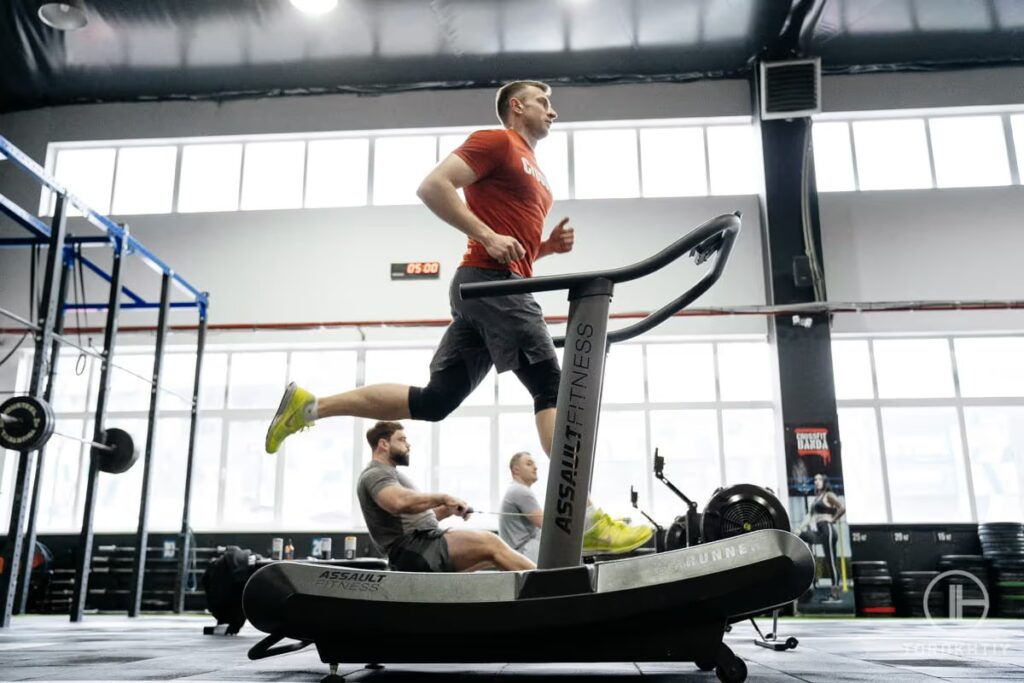 athlete in orange running on treadmill