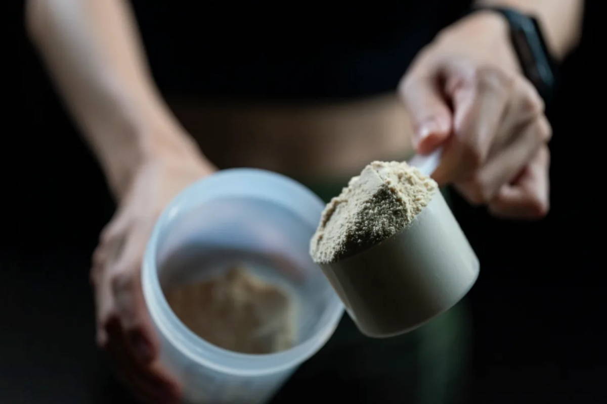 Man athlete making protein shake