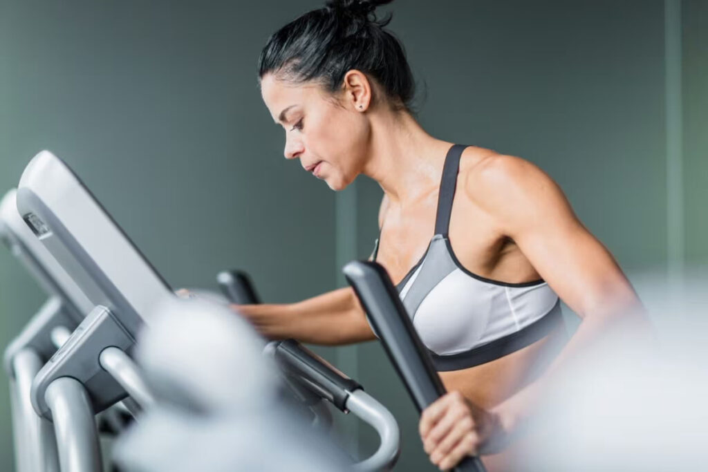 woman training on elliptical