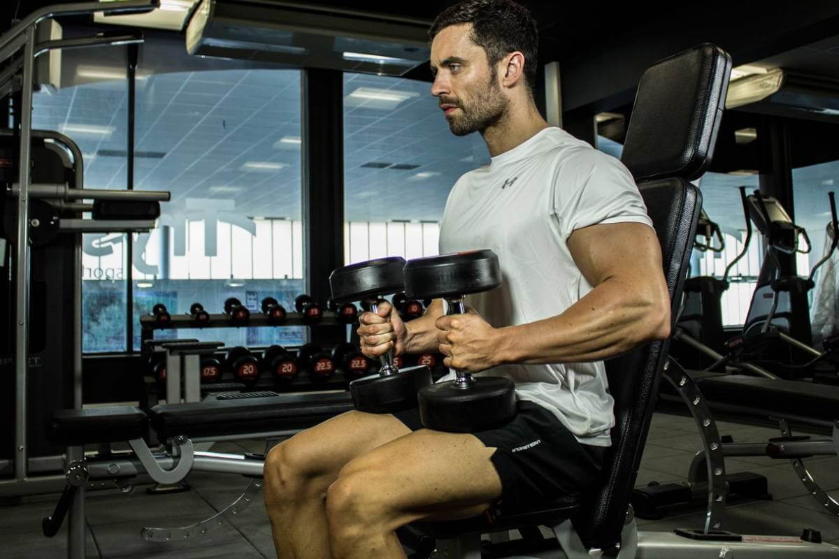 athlete training on a weight bench at gym