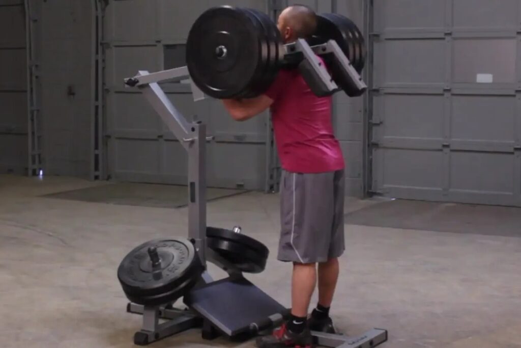 athlete using standing calf machine