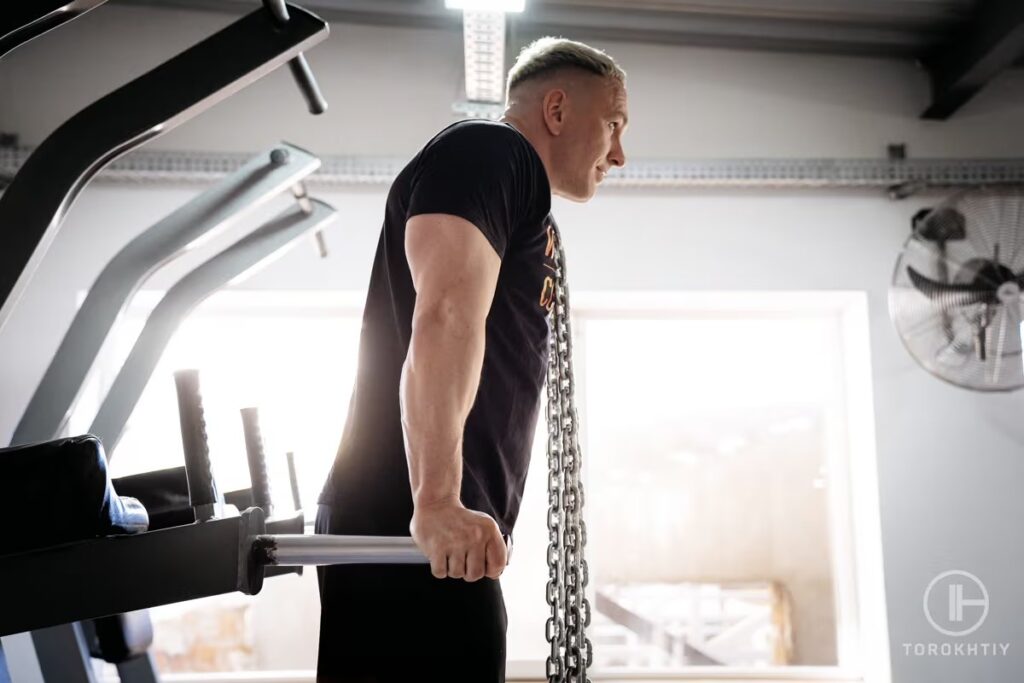 athlete with chains on bars