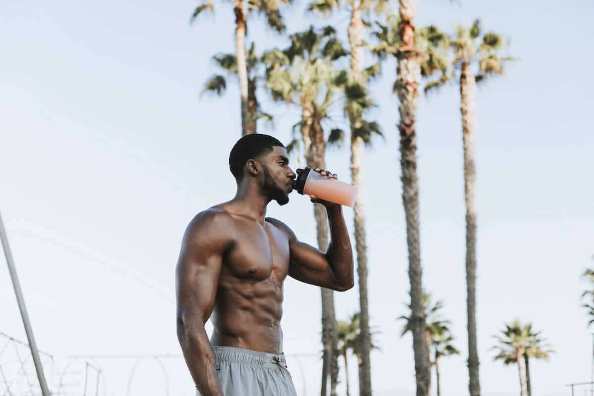 Athletes drinking protein shake in shaker