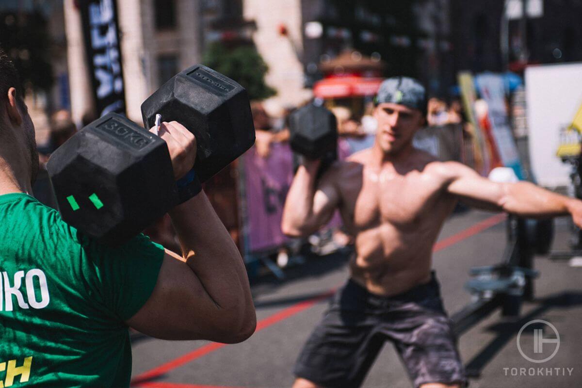 Athletes training with dumbbells