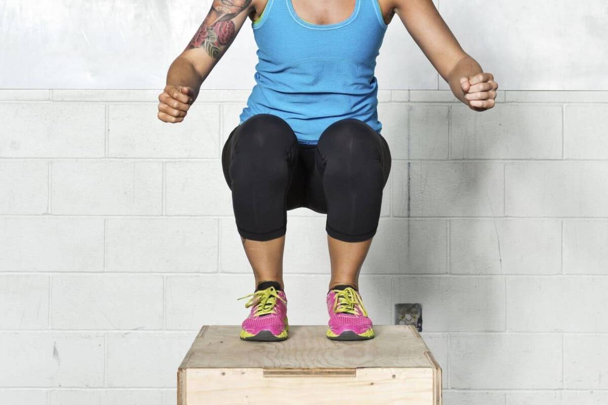 Female athlete doing plyo box workout