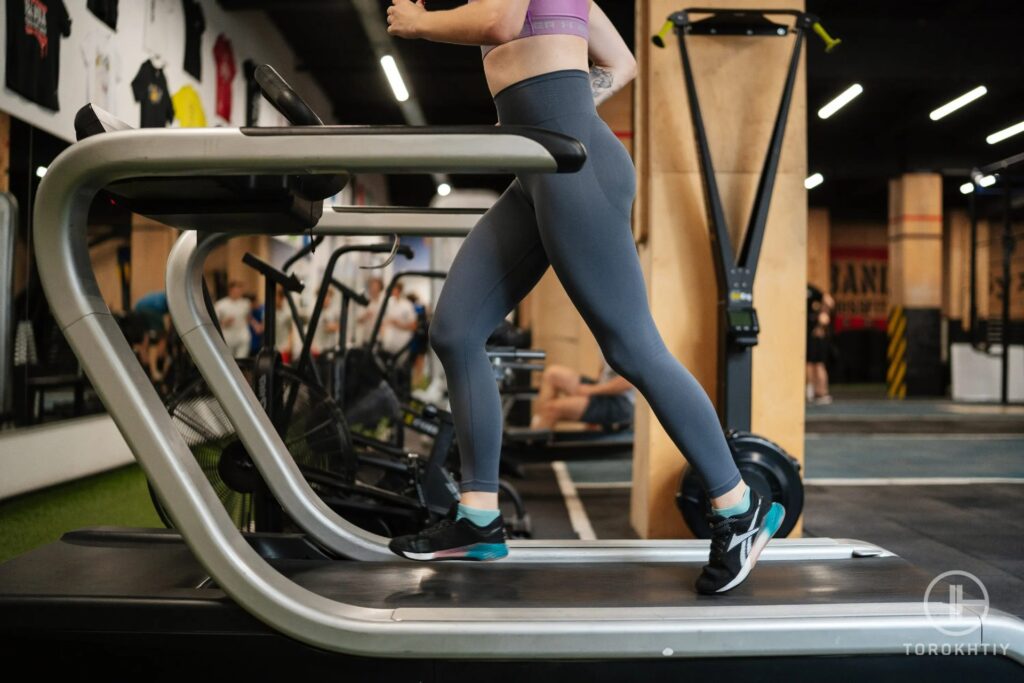 female athlete in pink running on treadmill