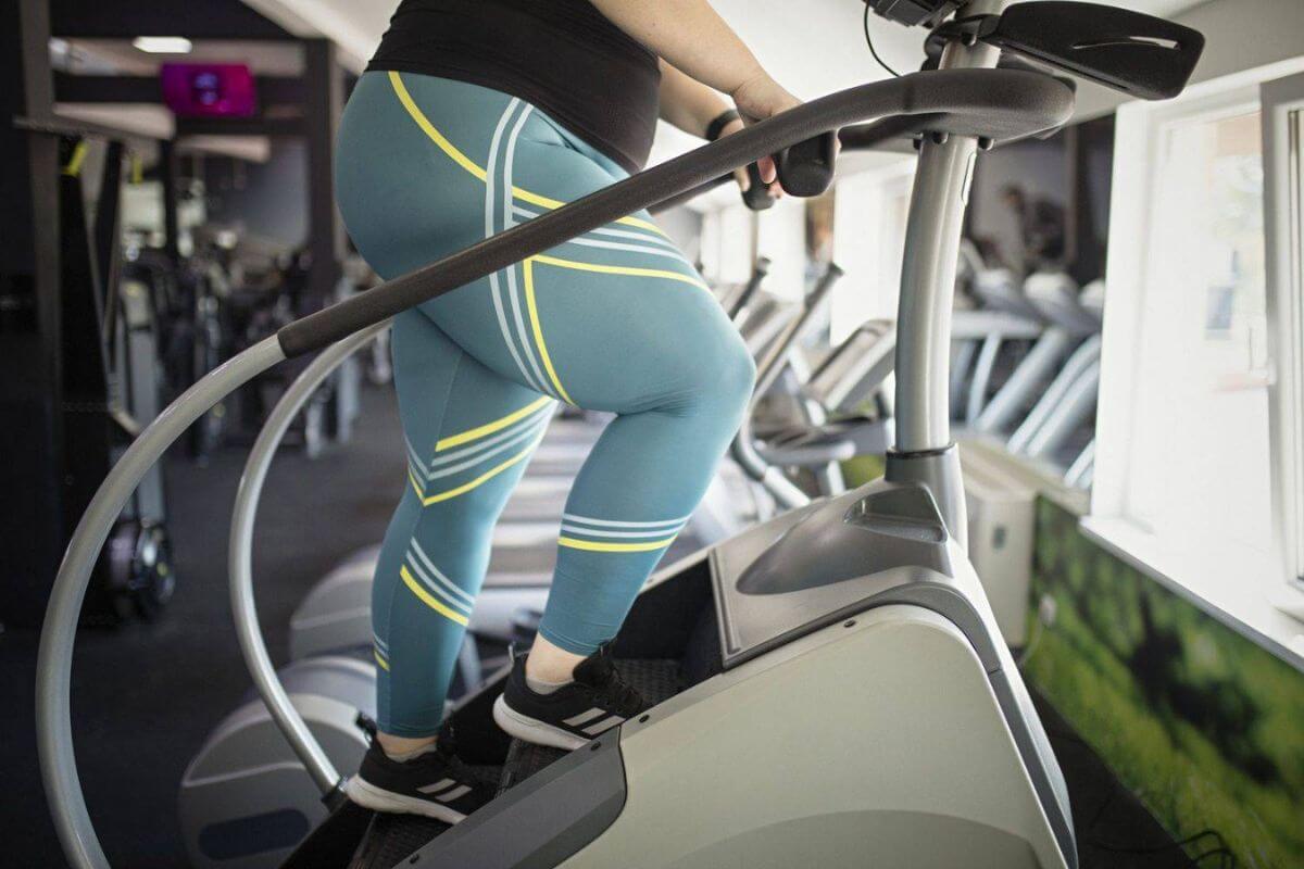 Athlete in leggings training on stairmaster machine