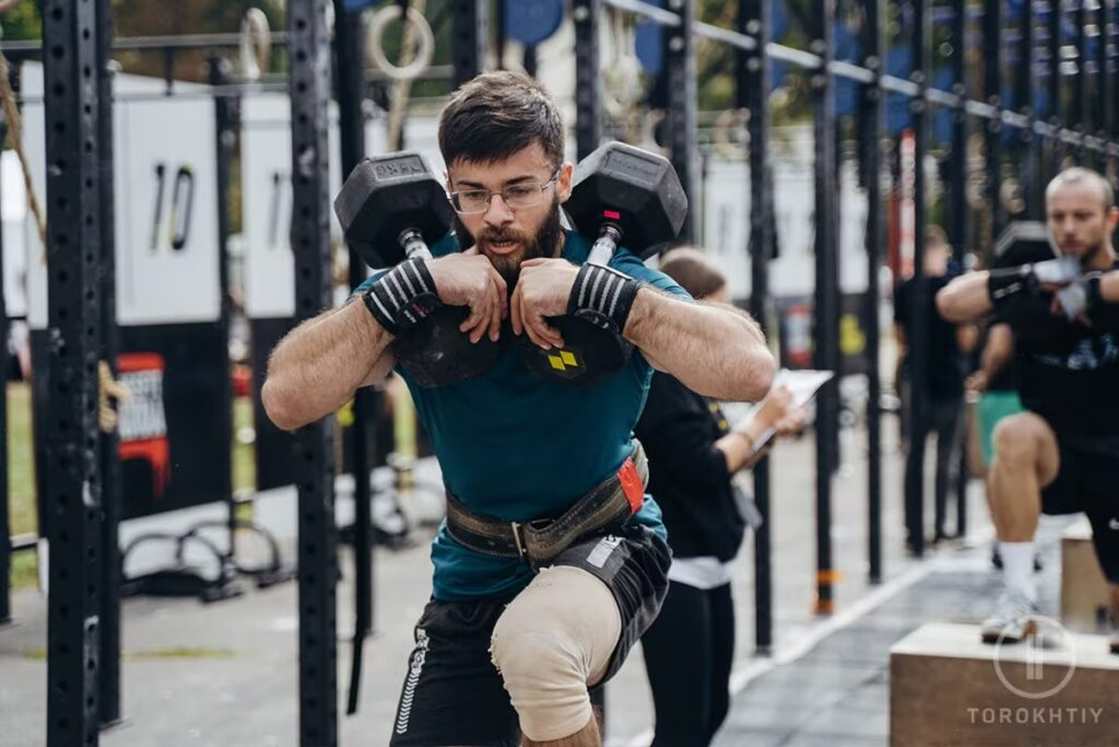 man competiton using dumbbell