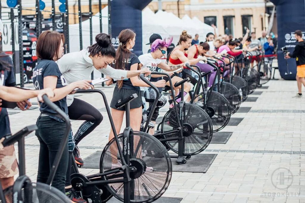 athletes training on air bikes