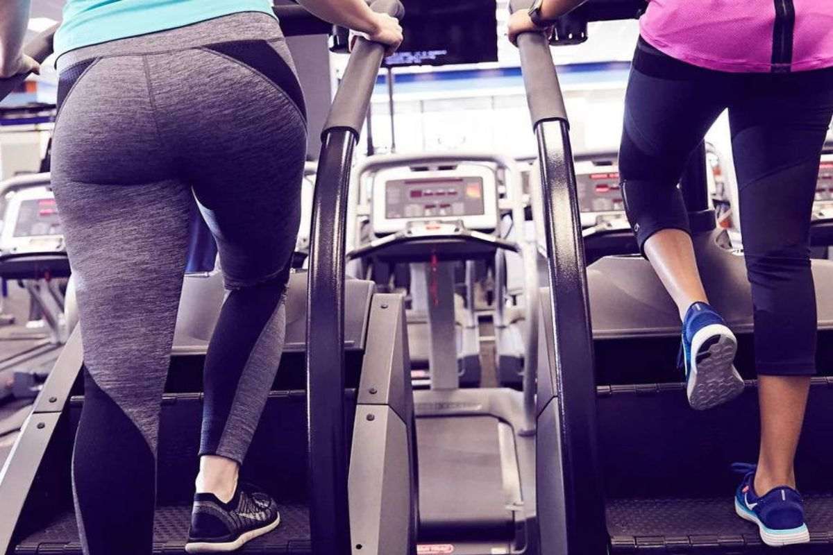 Female athletes training on stairmaster machine