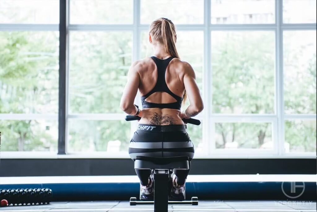 Athlete Rowing Machine Workout in Gym