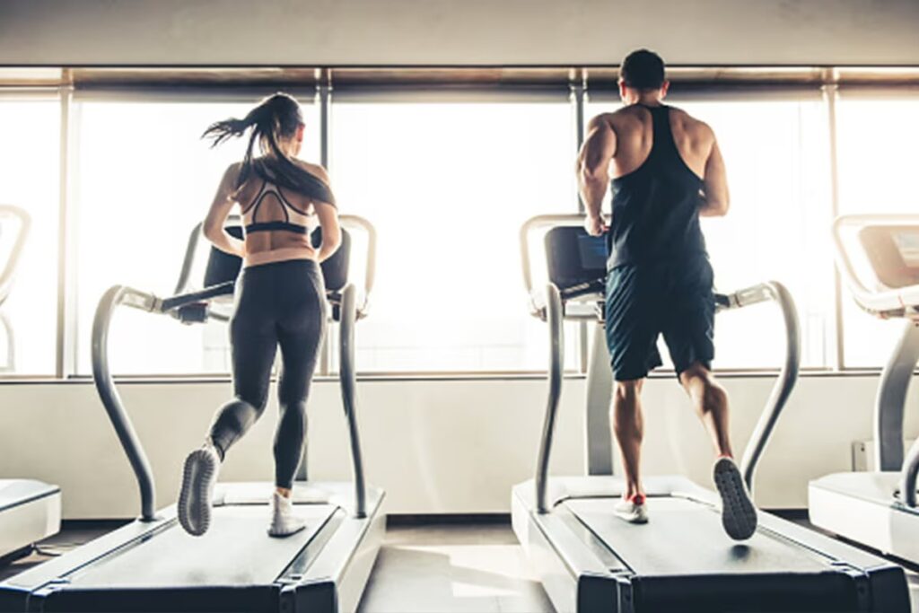 two athletes running on treadmills