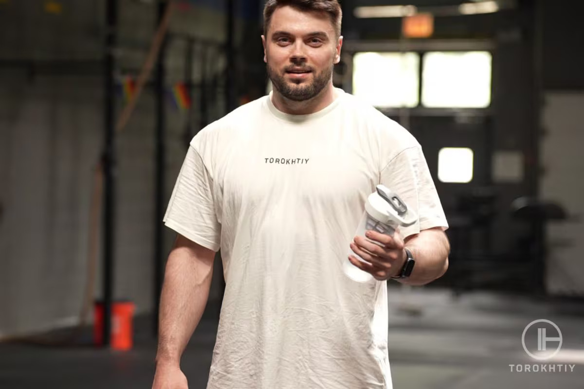 athlete holds protein bottle