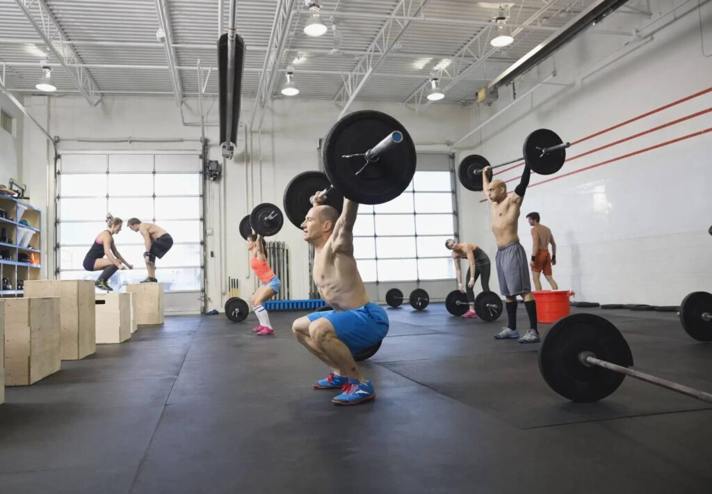 athlete holds lifted barbell