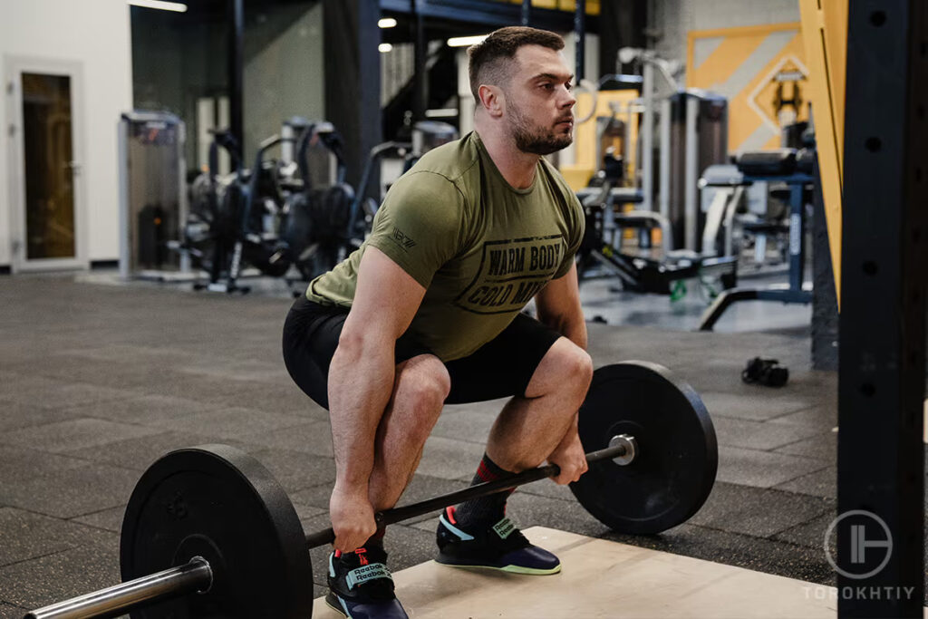 athlete man lifts barbell