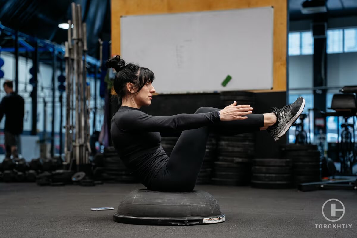 athlete woman doing exercise on bosu ball