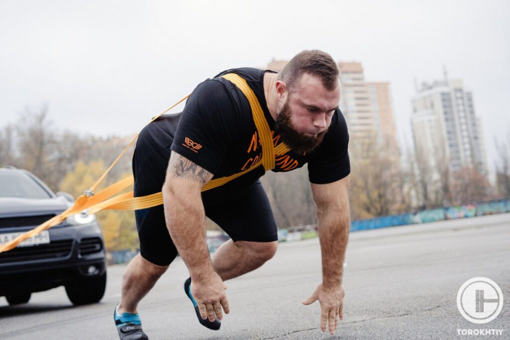 Strongman Pulling a Car