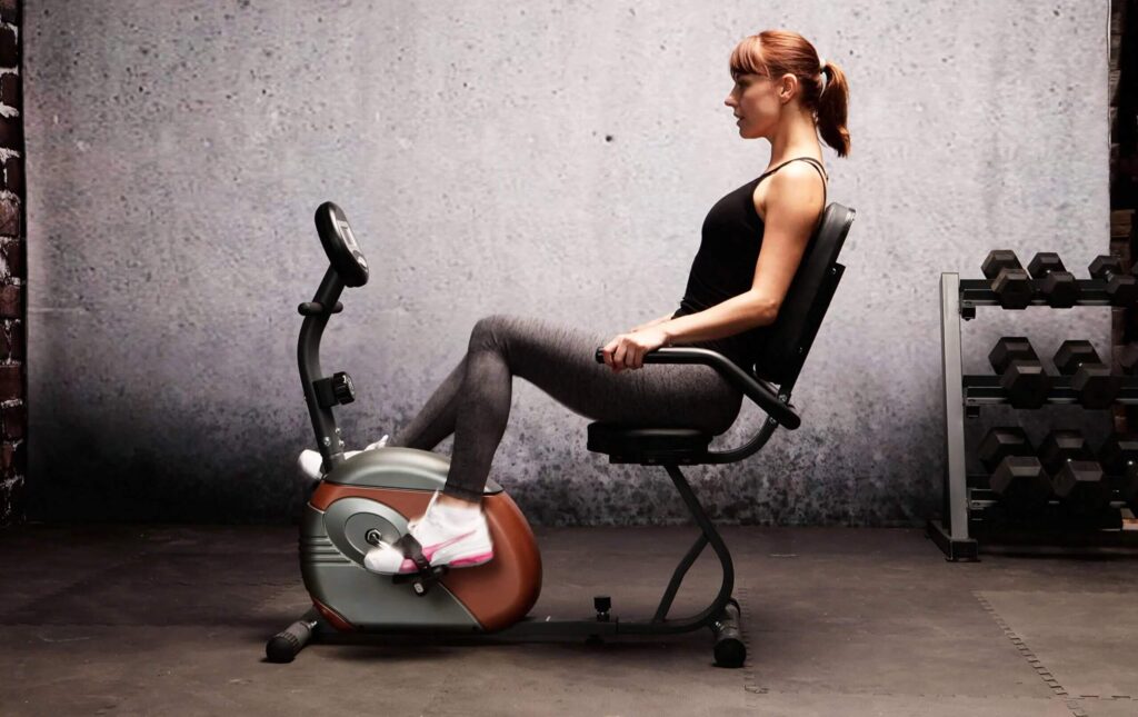 woman exercises on exercise bike