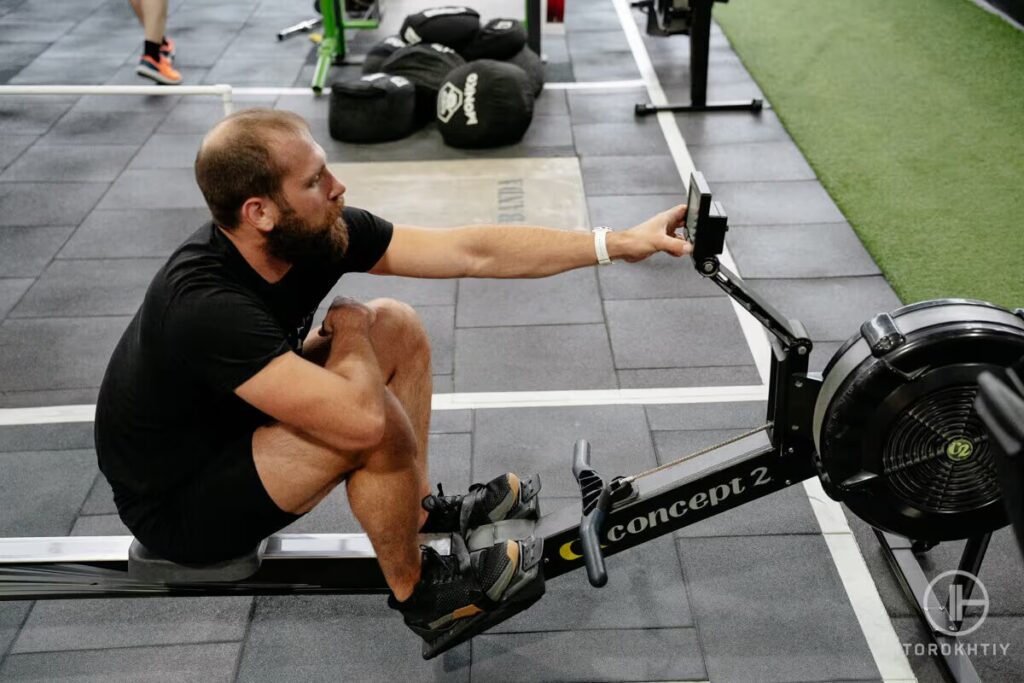 athlete configures rower