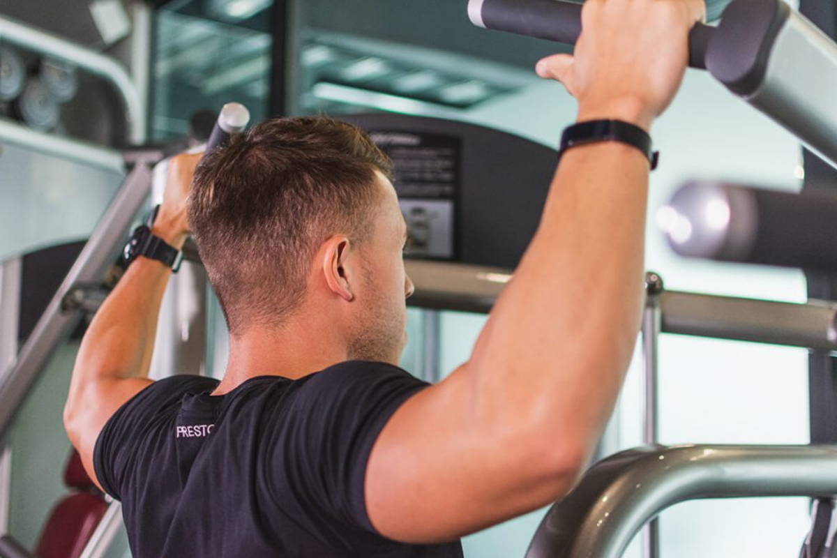 athlete training on the power tower at gym