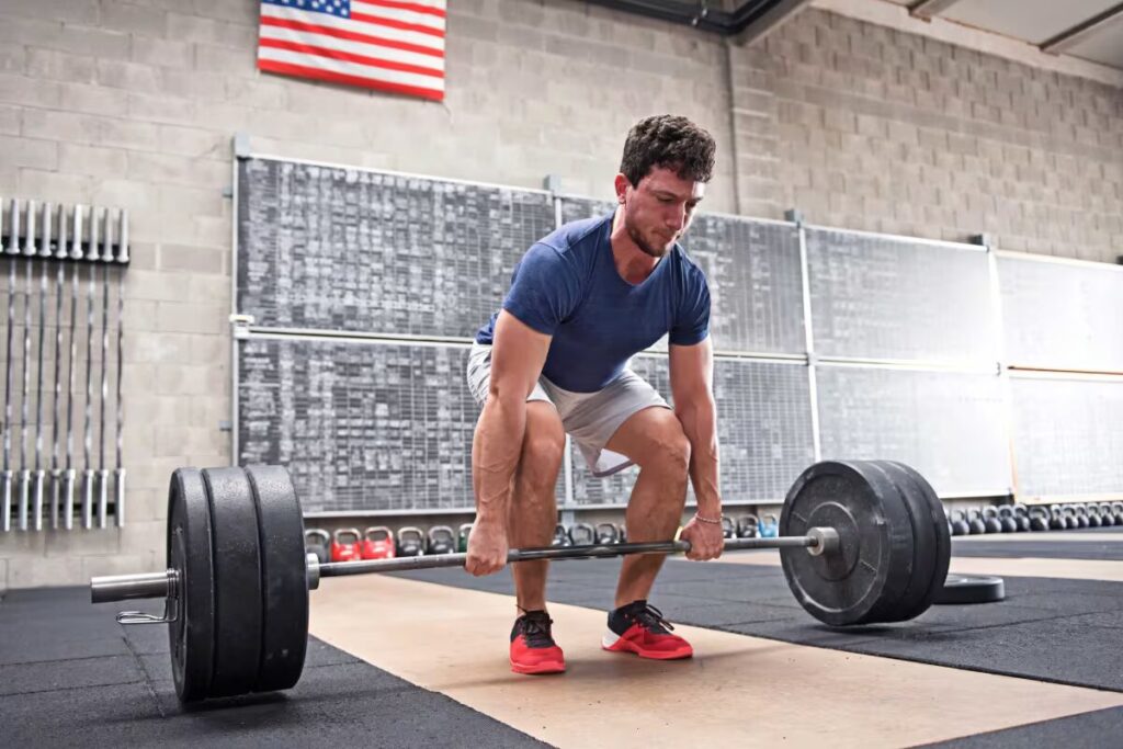 athlete man lifts trap bar