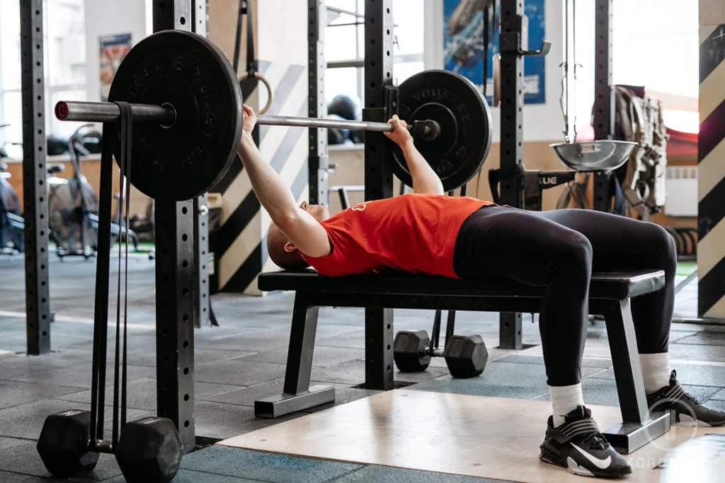 man does exercise with barbell in gym