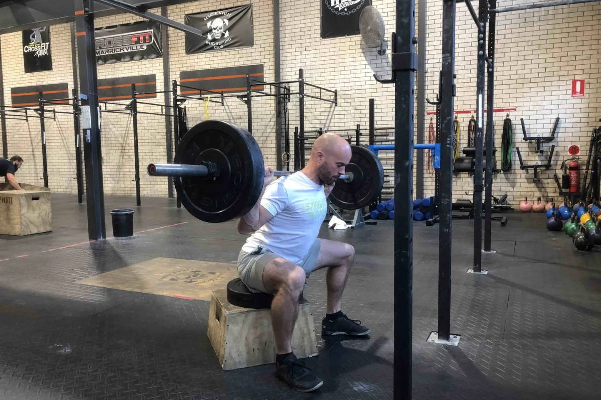 athlete exercising with plyo box box squats