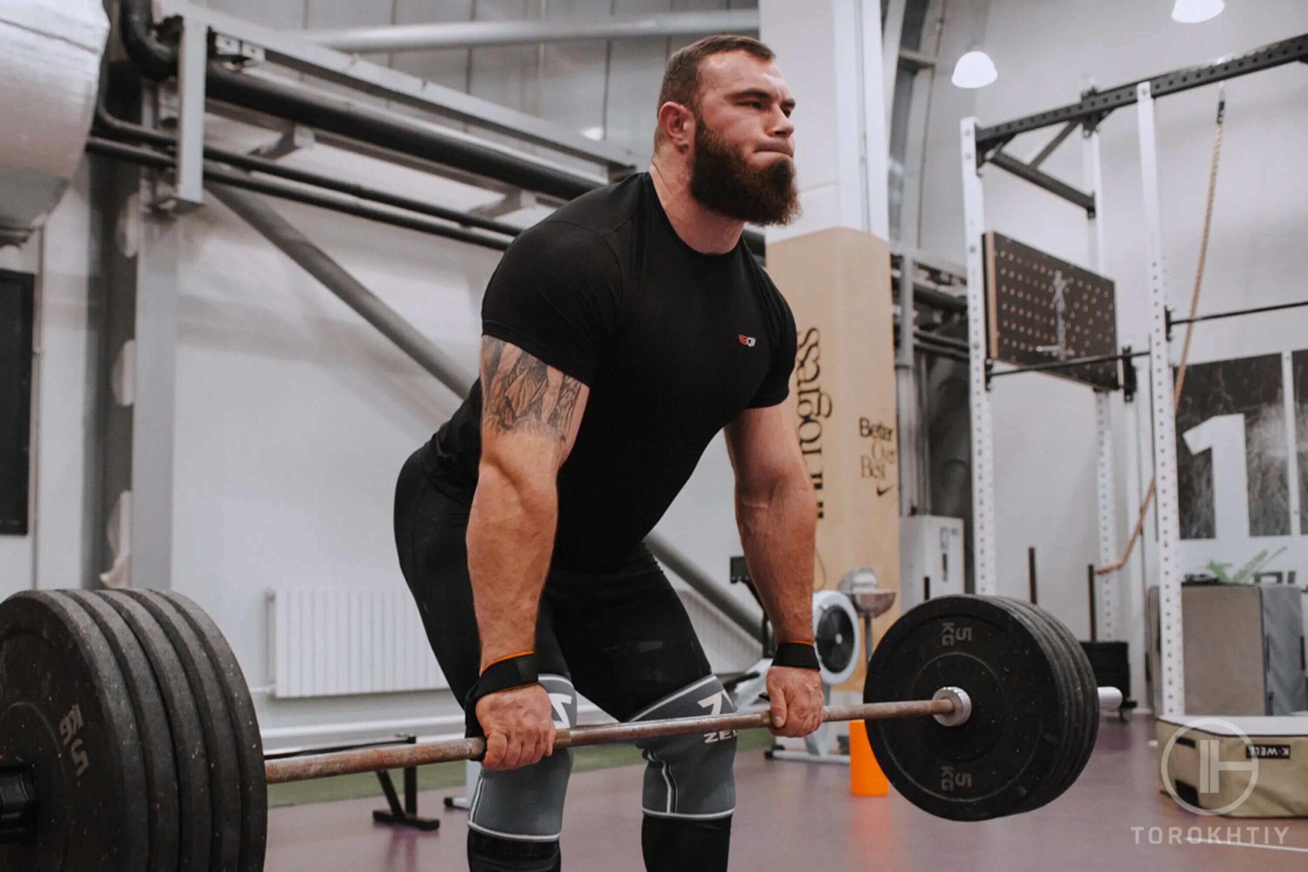 athlete man lifts heavy barbell
