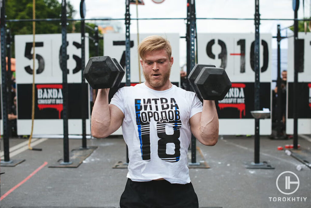 athlete working out with dumbbelles