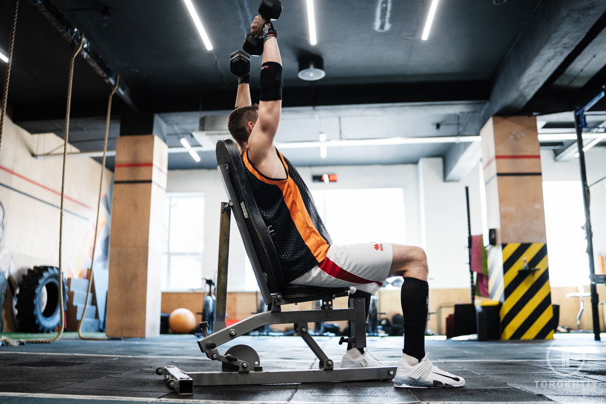 Athlete training on olympic weight bench