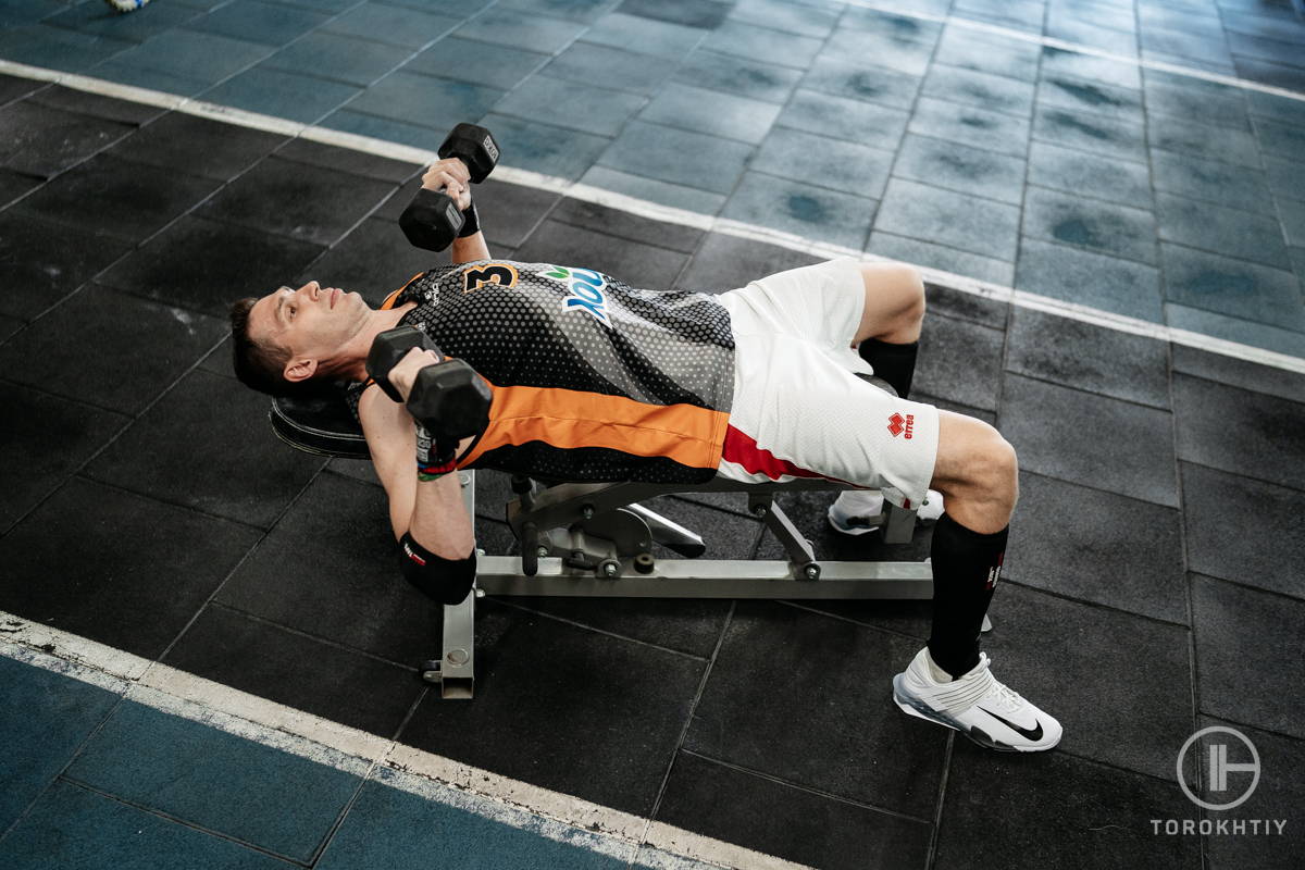 Athlete exercising on the olympic bench