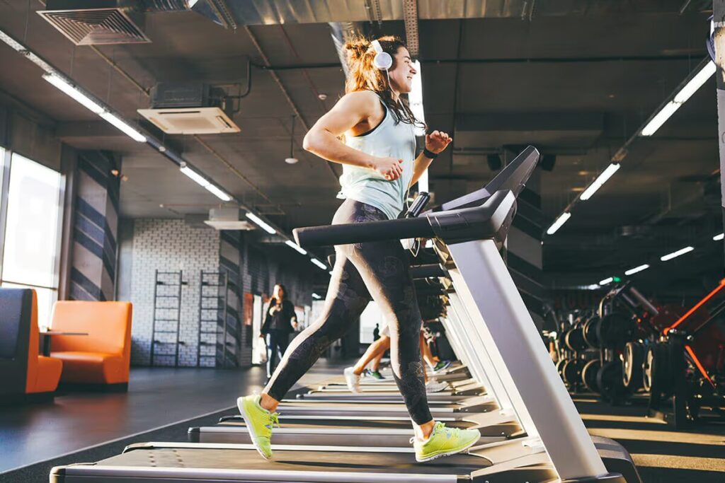 girl running on treadmill in gym