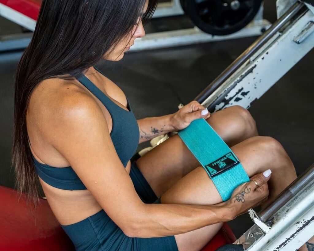 woman holds hip resistance band