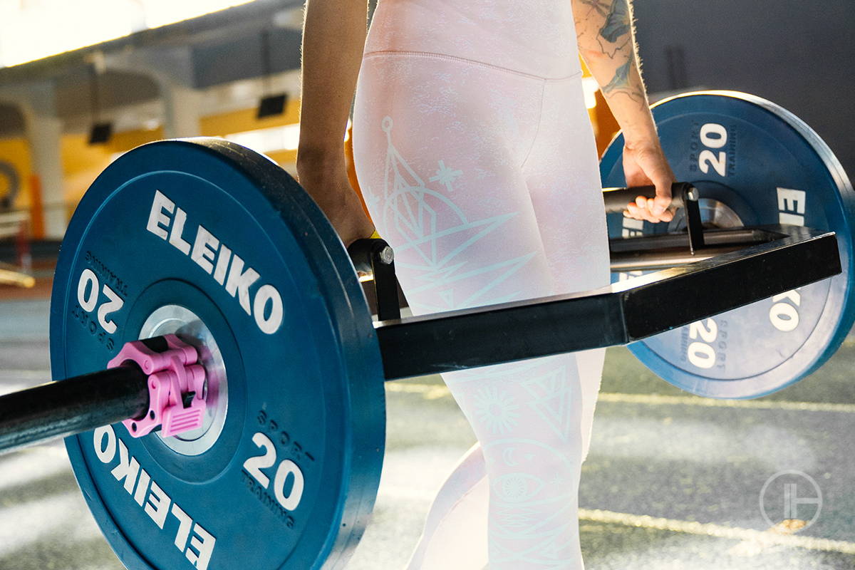 Athletes training with barbell at home