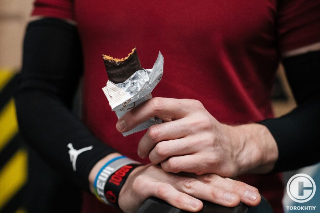 athlete eating protein bar