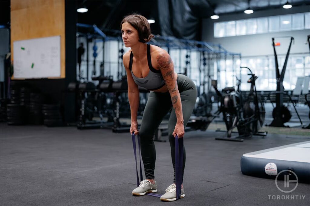 woman exercises with resistance band